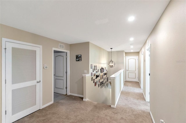 corridor with light colored carpet