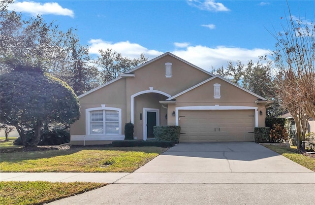 view of front of home with a garage and a front lawn