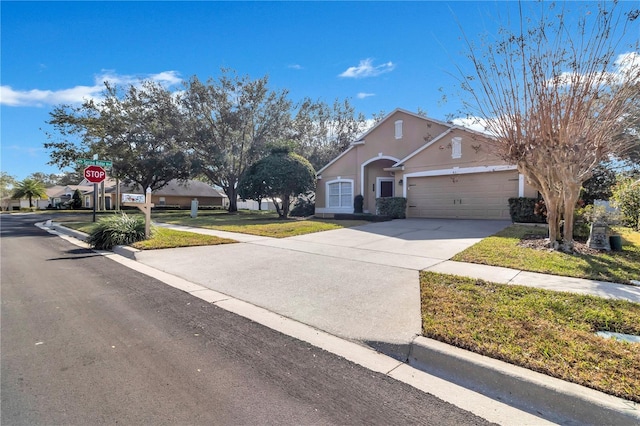 view of front of property with a garage and a front yard