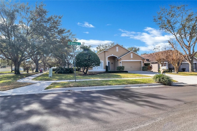 view of front of home with a garage and a front lawn