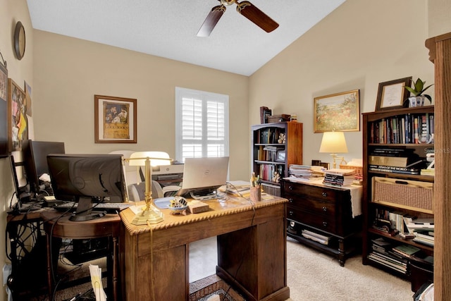 office area featuring ceiling fan, lofted ceiling, and light carpet