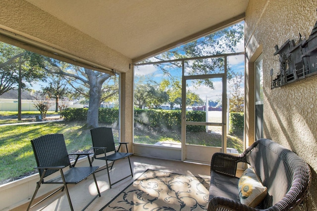 sunroom featuring lofted ceiling