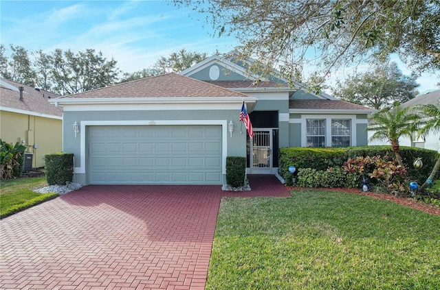 ranch-style house featuring a garage and a front lawn