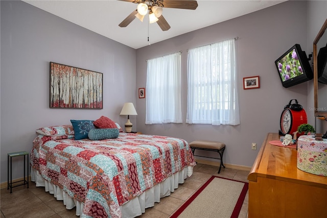 bedroom featuring light tile patterned floors and ceiling fan