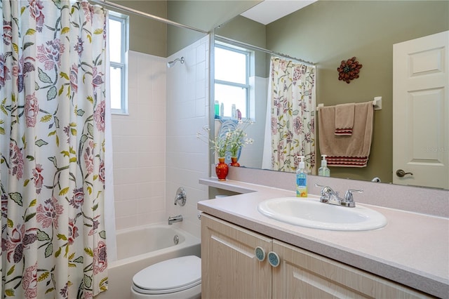 full bathroom featuring shower / tub combo with curtain, vanity, and toilet