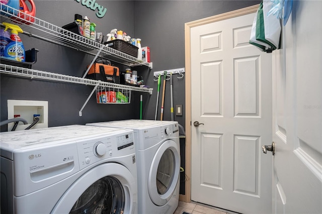 washroom featuring washer and clothes dryer and light tile patterned floors