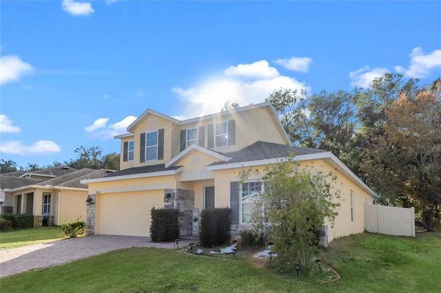 view of front facade with a garage and a front lawn