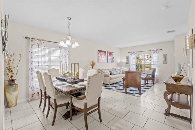 dining room with an inviting chandelier and light tile patterned floors