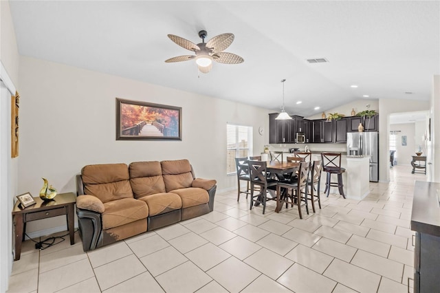 tiled dining area featuring vaulted ceiling and ceiling fan