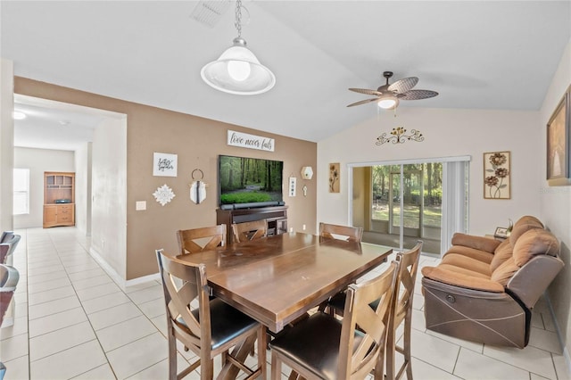 tiled dining space featuring lofted ceiling and ceiling fan