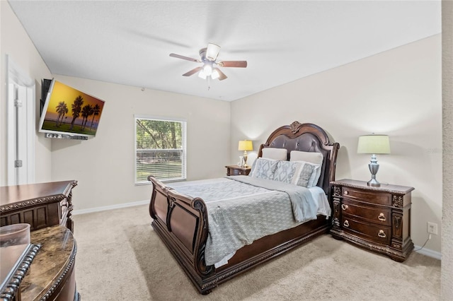 bedroom with ceiling fan and light colored carpet