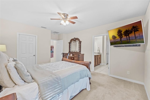 carpeted bedroom with ceiling fan and ensuite bath