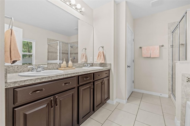 bathroom with tile patterned floors, vanity, and an enclosed shower