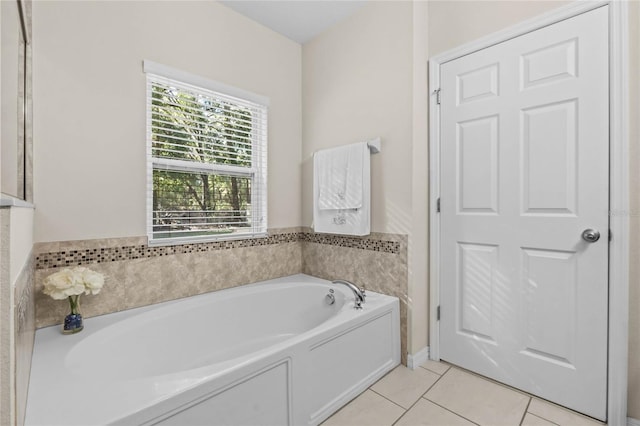 bathroom with tile patterned flooring and a bathing tub