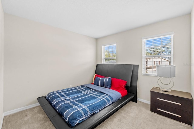 bedroom featuring light carpet