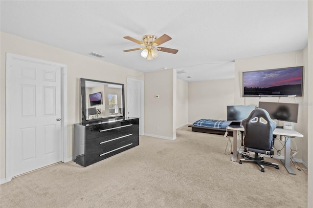 carpeted office space with ceiling fan