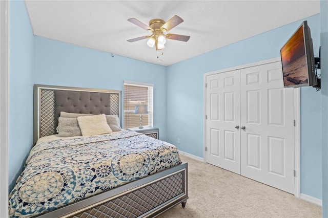 carpeted bedroom with a closet and ceiling fan