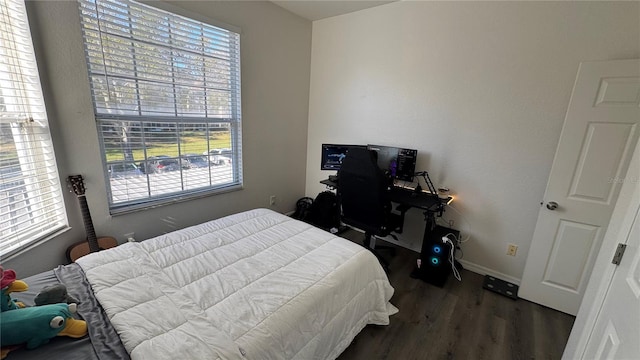 bedroom with dark hardwood / wood-style floors