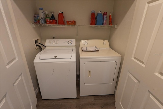 clothes washing area featuring washing machine and dryer and dark hardwood / wood-style flooring