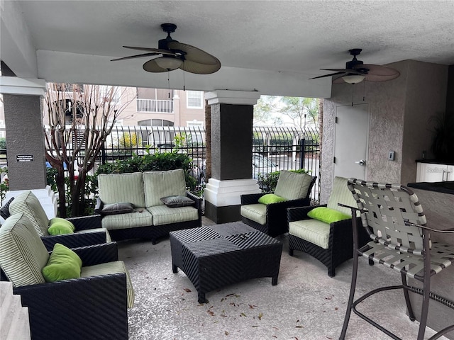 view of patio / terrace with an outdoor living space, ceiling fan, and a water view