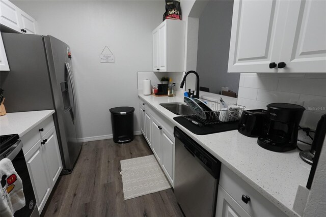 kitchen featuring white cabinetry, dishwasher, sink, and light stone counters