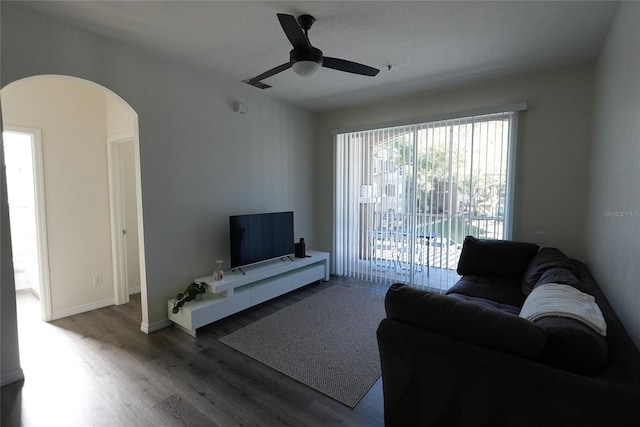 living room with wood-type flooring and ceiling fan