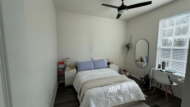 bedroom with dark hardwood / wood-style floors and ceiling fan