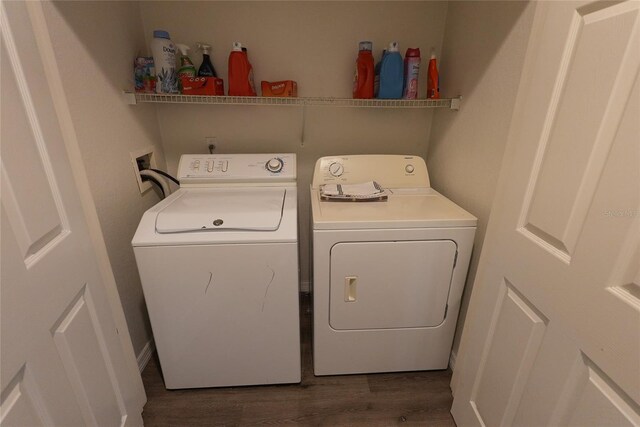 laundry area featuring washing machine and dryer and dark hardwood / wood-style flooring