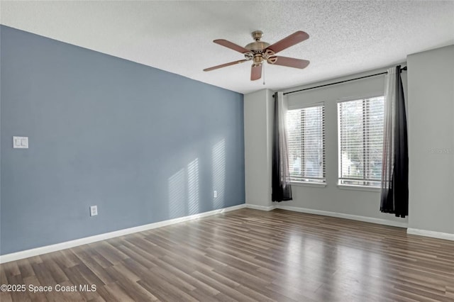 spare room featuring hardwood / wood-style flooring, ceiling fan, and a textured ceiling