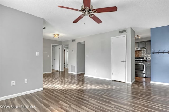 unfurnished living room with dark hardwood / wood-style flooring, ceiling fan, and a textured ceiling