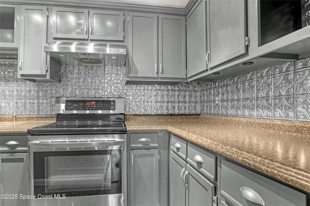 kitchen featuring stainless steel electric range oven, gray cabinets, extractor fan, and backsplash