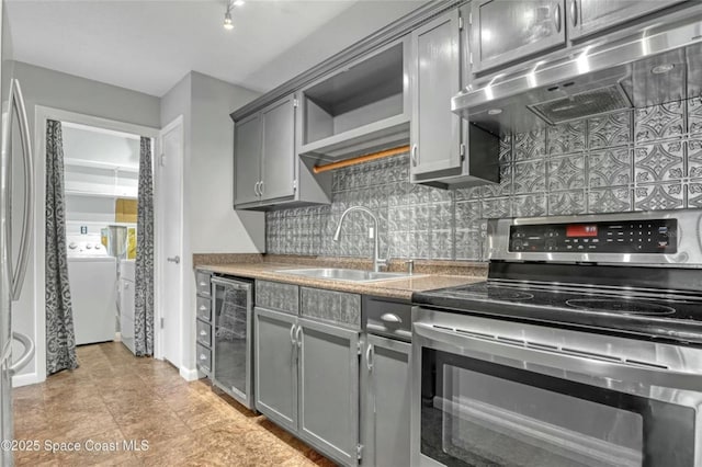 kitchen featuring stainless steel appliances, extractor fan, and gray cabinetry