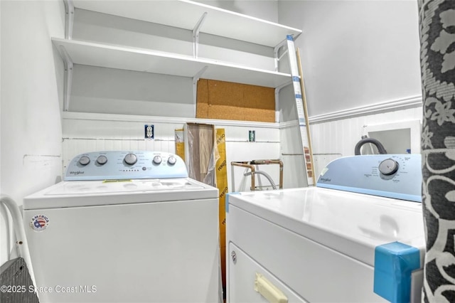 clothes washing area with separate washer and dryer