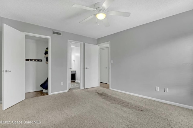 unfurnished bedroom with ceiling fan, light colored carpet, and a closet