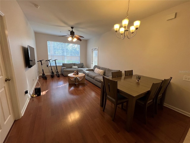 dining area featuring ceiling fan with notable chandelier and dark hardwood / wood-style floors