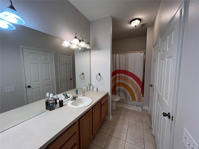 bathroom featuring vanity, tile patterned floors, a chandelier, and toilet