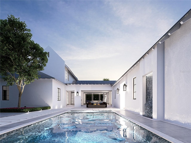 view of pool at dusk