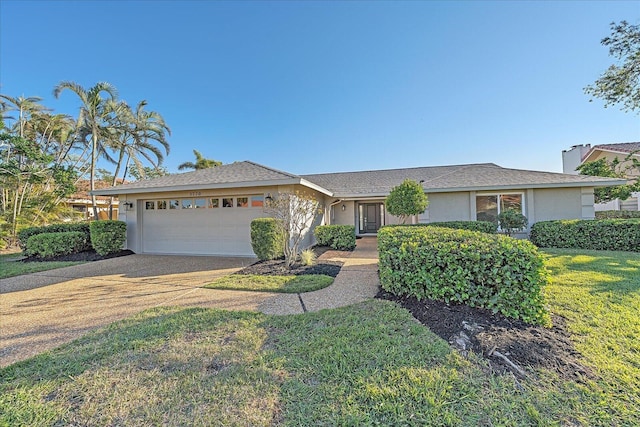 ranch-style home with a garage and a front yard