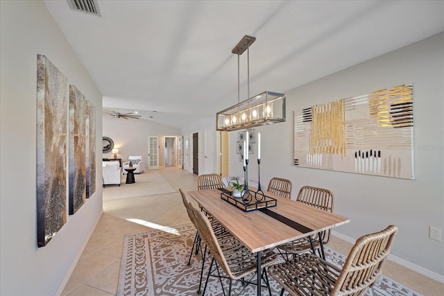 tiled dining space with vaulted ceiling and ceiling fan