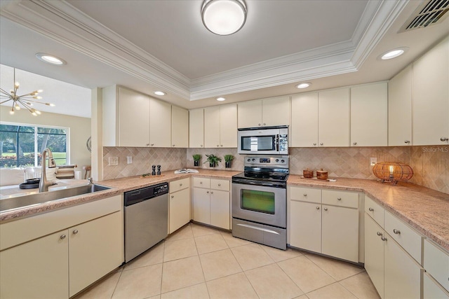 kitchen featuring sink, backsplash, ornamental molding, and stainless steel appliances