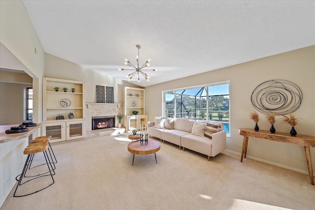 living room with light carpet, built in shelves, a premium fireplace, and a textured ceiling