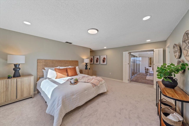 carpeted bedroom with access to outside and a textured ceiling