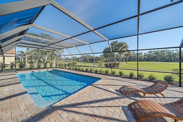 view of swimming pool with a lanai, a patio, and a lawn