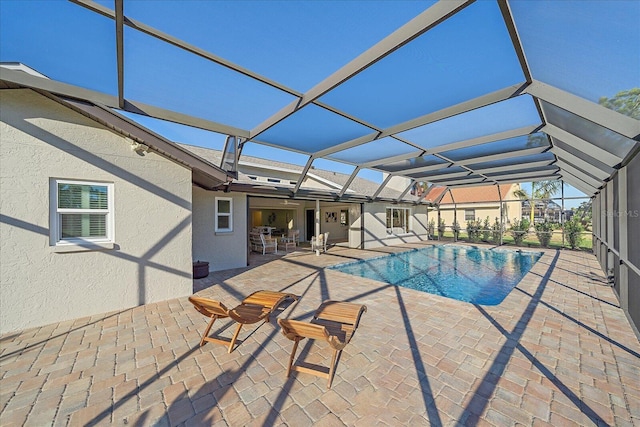 view of swimming pool featuring a patio and a lanai