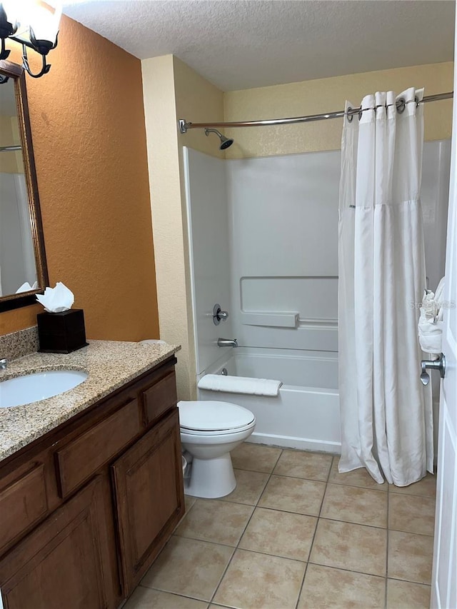 full bathroom with shower / bath combo, tile patterned flooring, vanity, a textured ceiling, and toilet