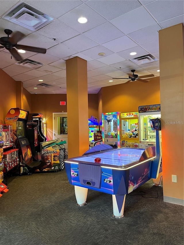 rec room featuring a drop ceiling, carpet floors, and ceiling fan