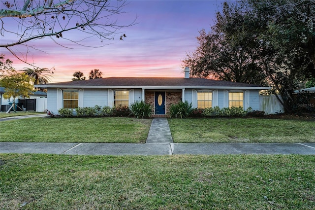 ranch-style house with a lawn