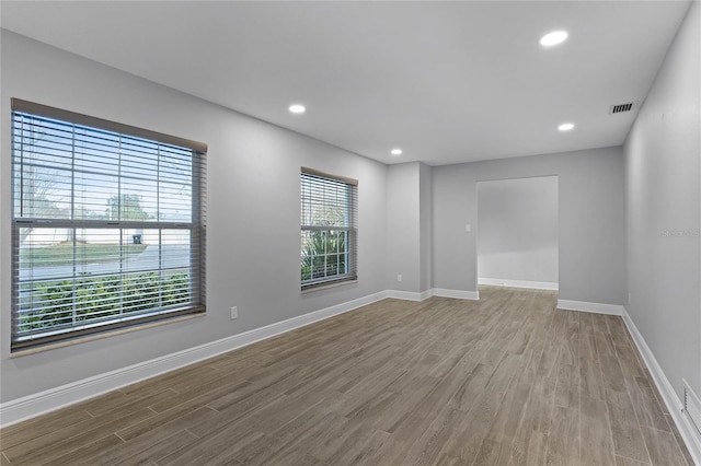 empty room with hardwood / wood-style flooring