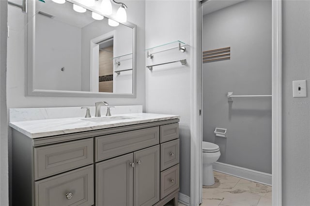 bathroom featuring vanity and toilet