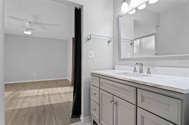 bathroom featuring vanity, hardwood / wood-style flooring, and ceiling fan